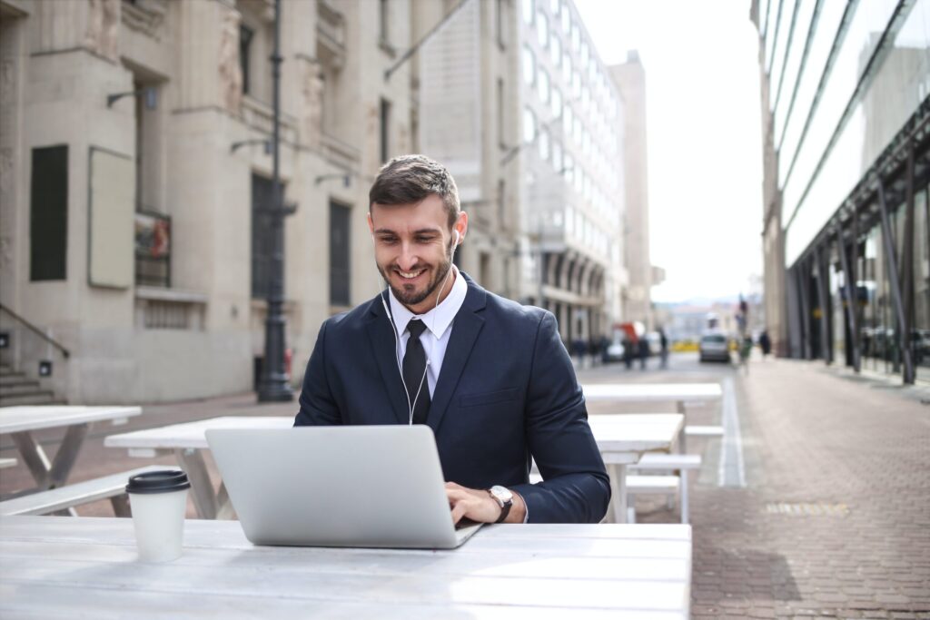 man-in-black-suit-jacket-using-macbook